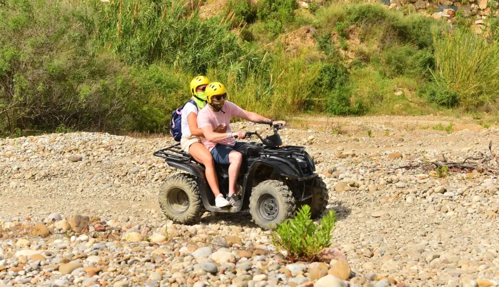 Alanya quad bike safari couple riding ATV through rocky route