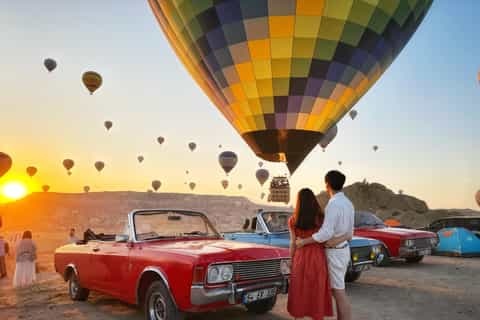 Classic convertible car and balloons in Cappadocia