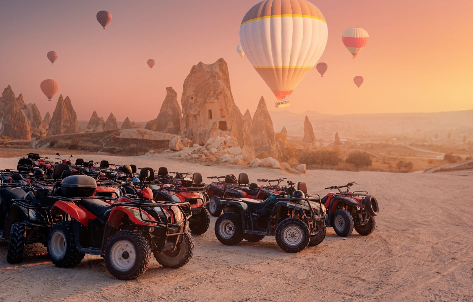 ATV vehicles parked with balloon in the background in Cappadocia